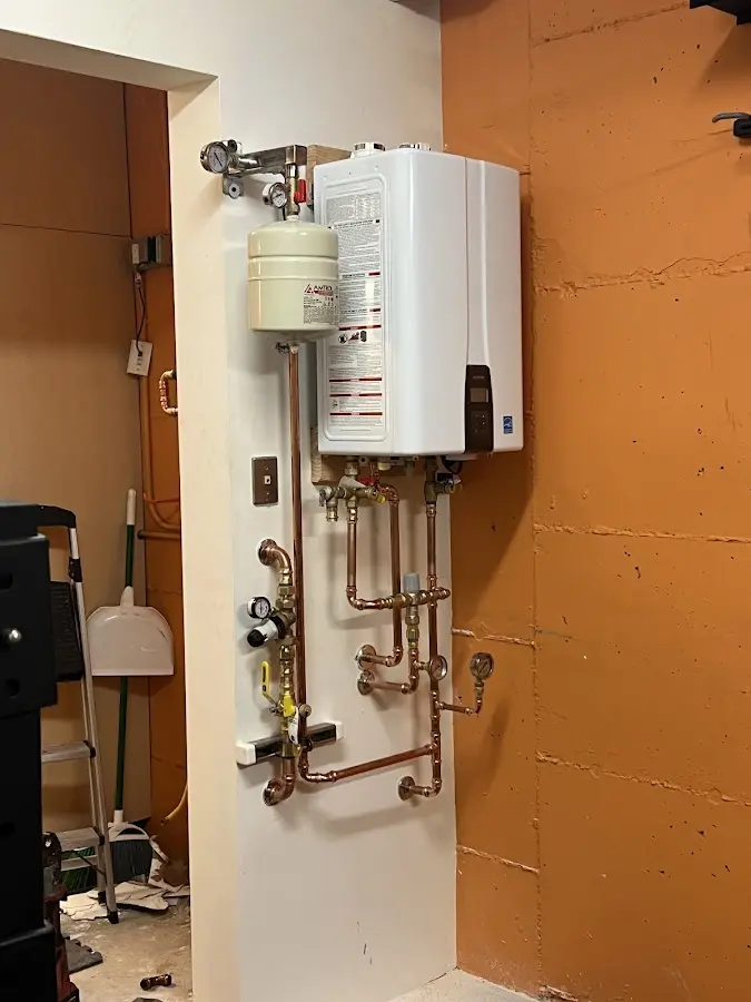 Plumbing technician inspecting water heater connections in El Dorado Hills